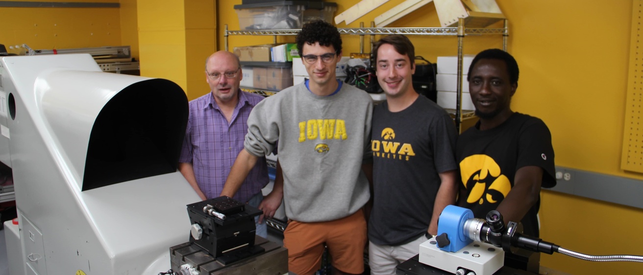 Matthew McGill, Nathan Bradford, Grant Finneman, and Bolaji Oladipo pose for a photo in the lab