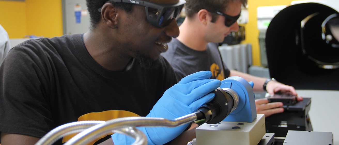 Bolaji Oladipo and Grant Finneman work with the autocollimator and alignment